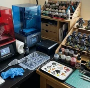 Monochrome LCD resin 3D printers with painted tabletop miniature models (AI Generated Image)